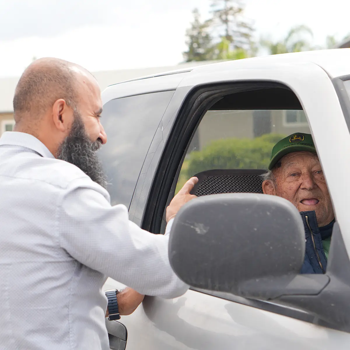 Taha Saleh speaking with a Porterville resident during a community conversation.