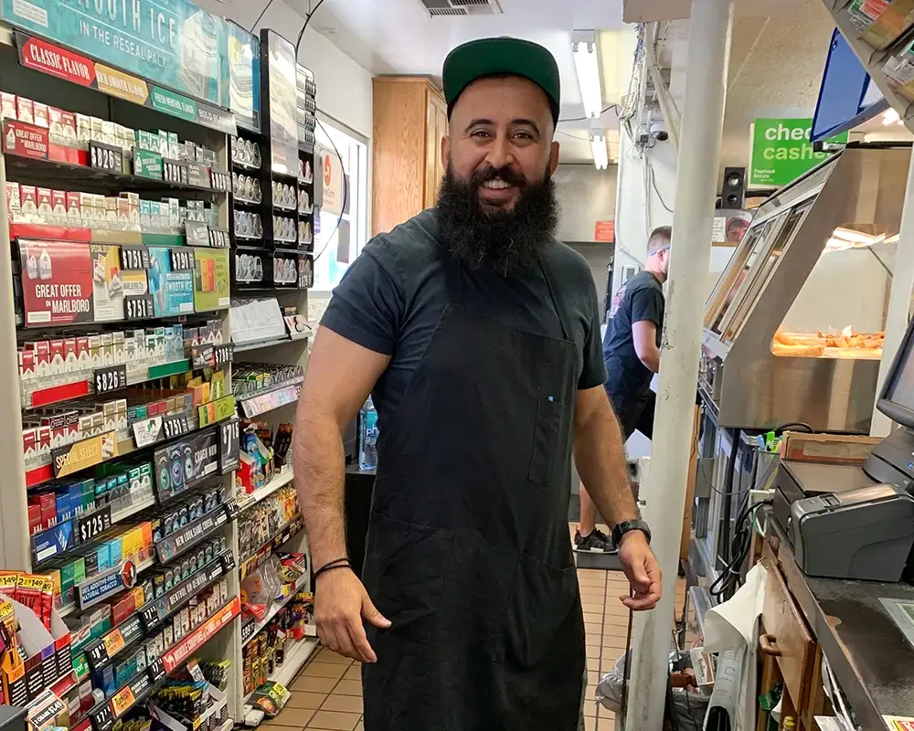Taha Saleh working in the family business that helped shape his connection to the Porterville community.